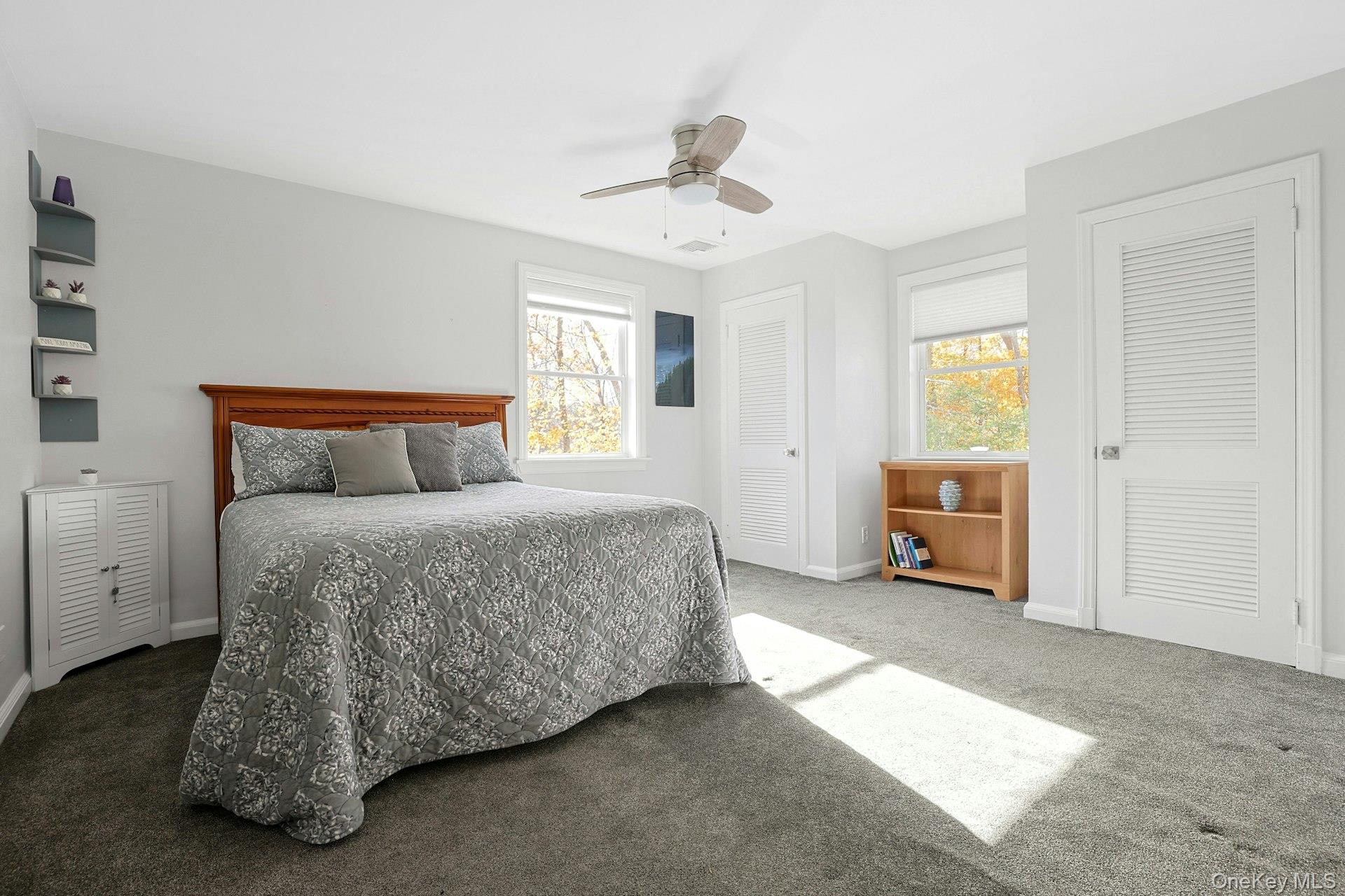 8 Creemer Road Armonk, NY 10504 - Photo 20 of 38 a bedroom with a bed and a chandelier