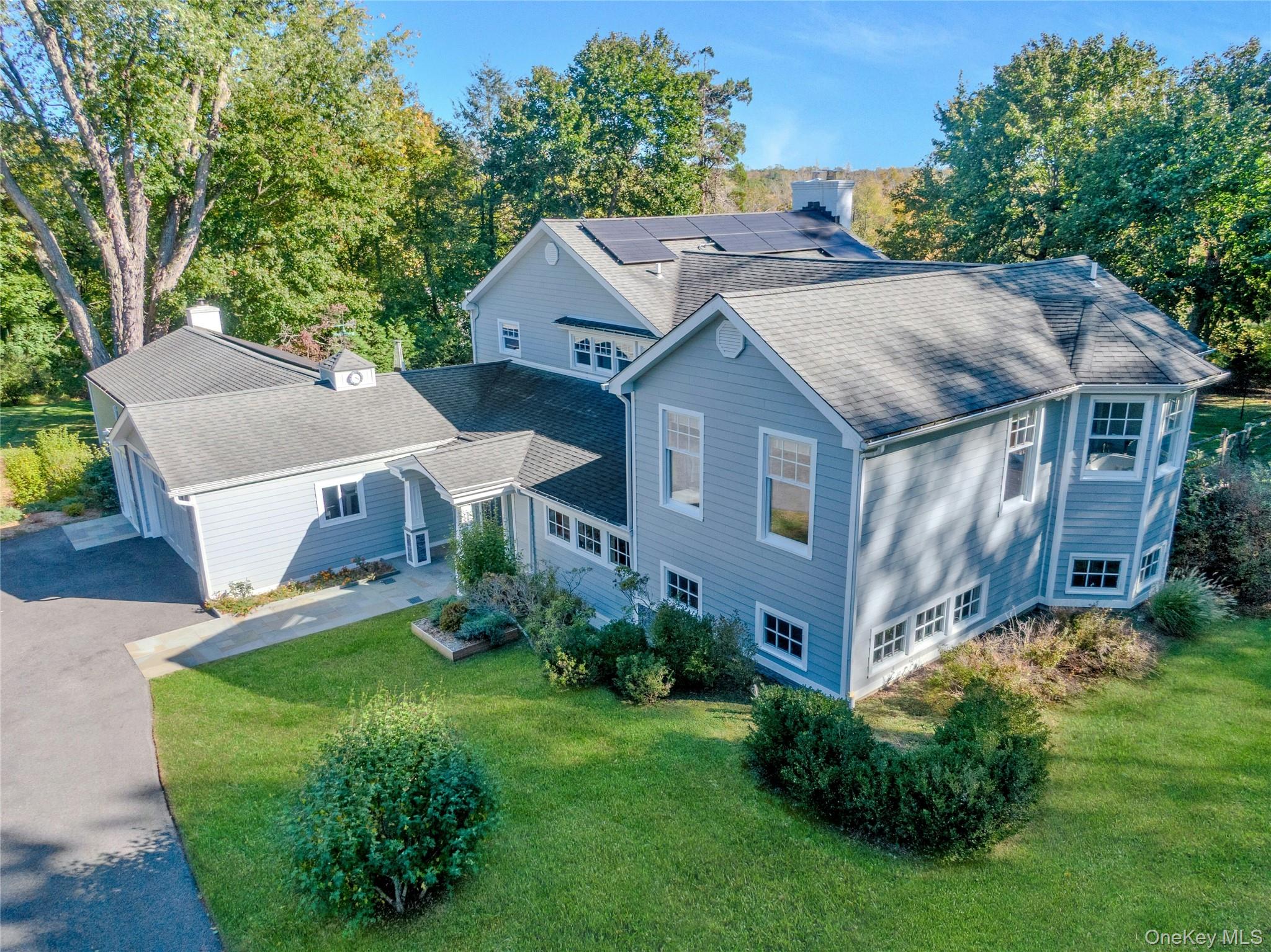 8 Creemer Road Armonk, NY 10504 - Photo 28 of 38 a aerial view of a house next to a big yard and large trees