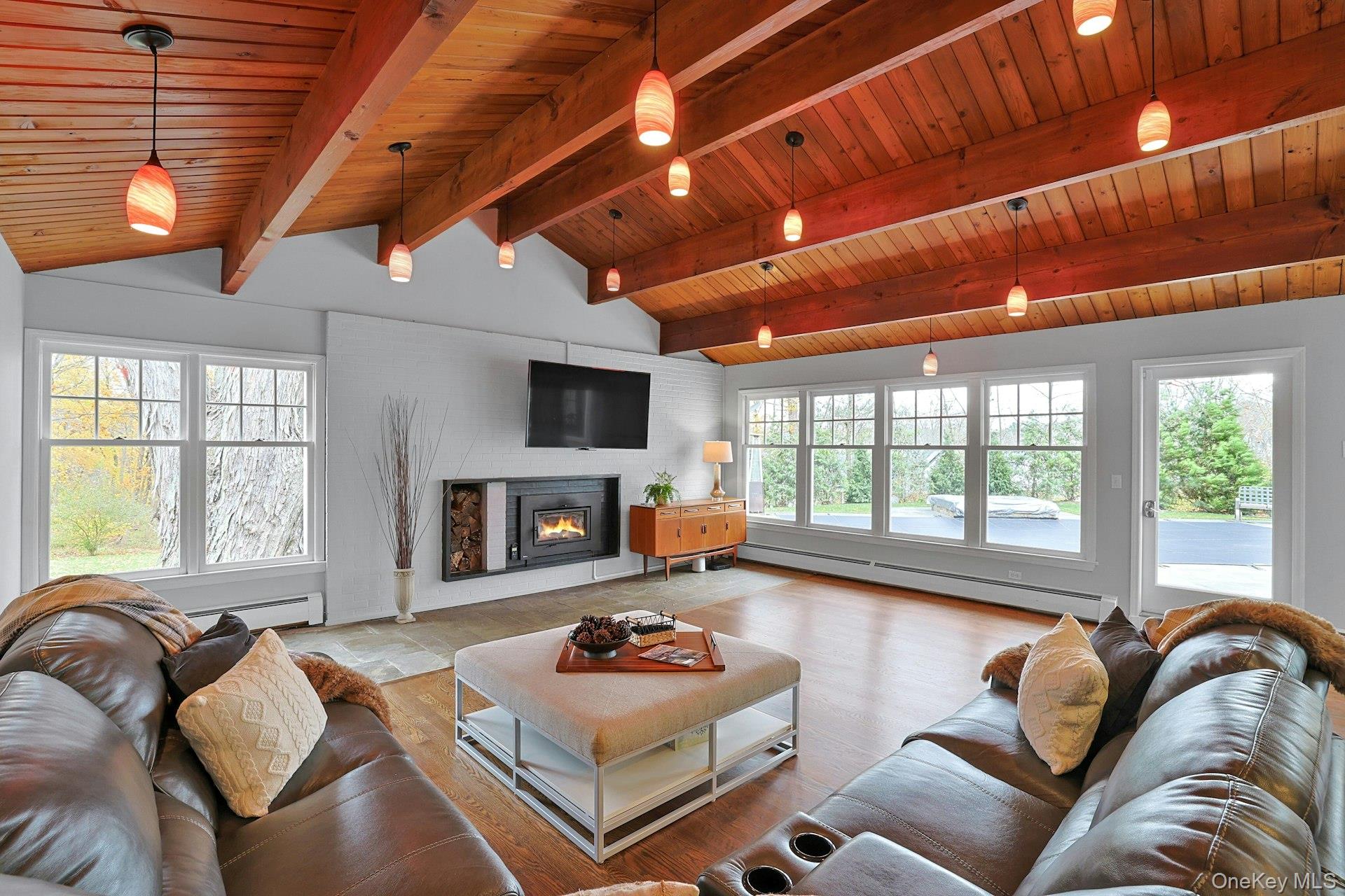 8 Creemer Road Armonk, NY 10504 - Photo 7 of 38 a living room with furniture a flat screen tv and a fireplace