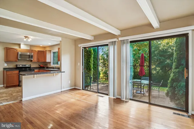 a view of a kitchen with furniture wooden floor and an entryway