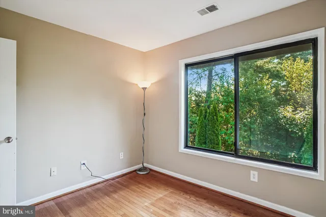 a view of room with window and hardwood floor