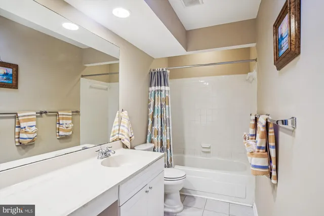 a bathroom with a sink toilet vanity and shower