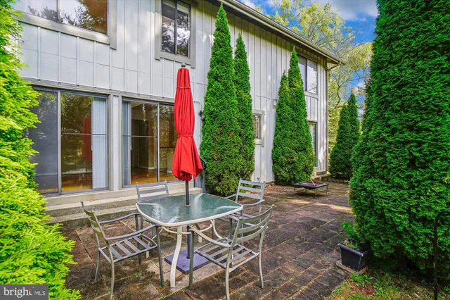 a view of patio with a table and chairs and potted plants