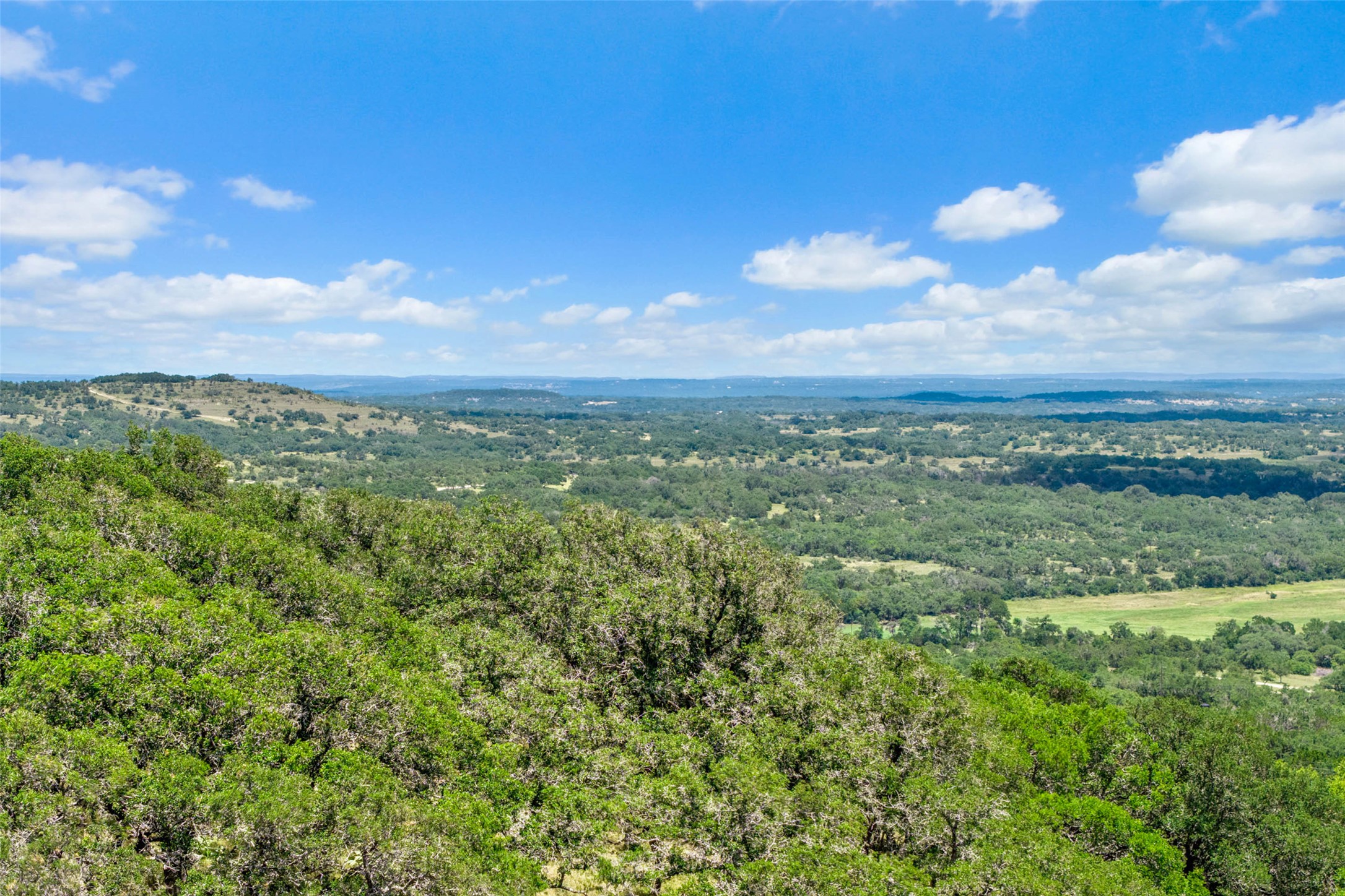 5032 Kendalia Road Blanco, TX 78606 - Photo 22 of 40 a view of a city with lush green forest