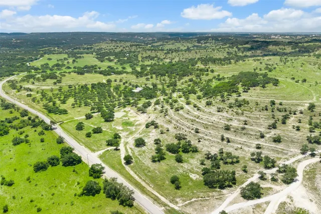a view of a big yard with large trees