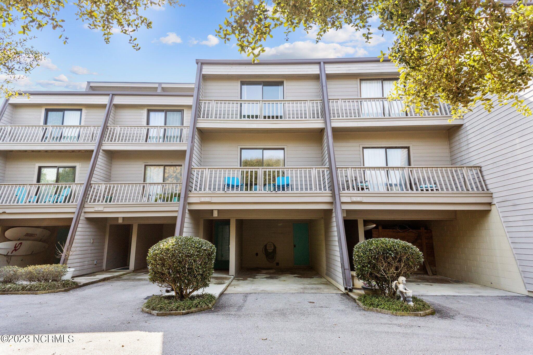 Unit has teal chairs on balcony