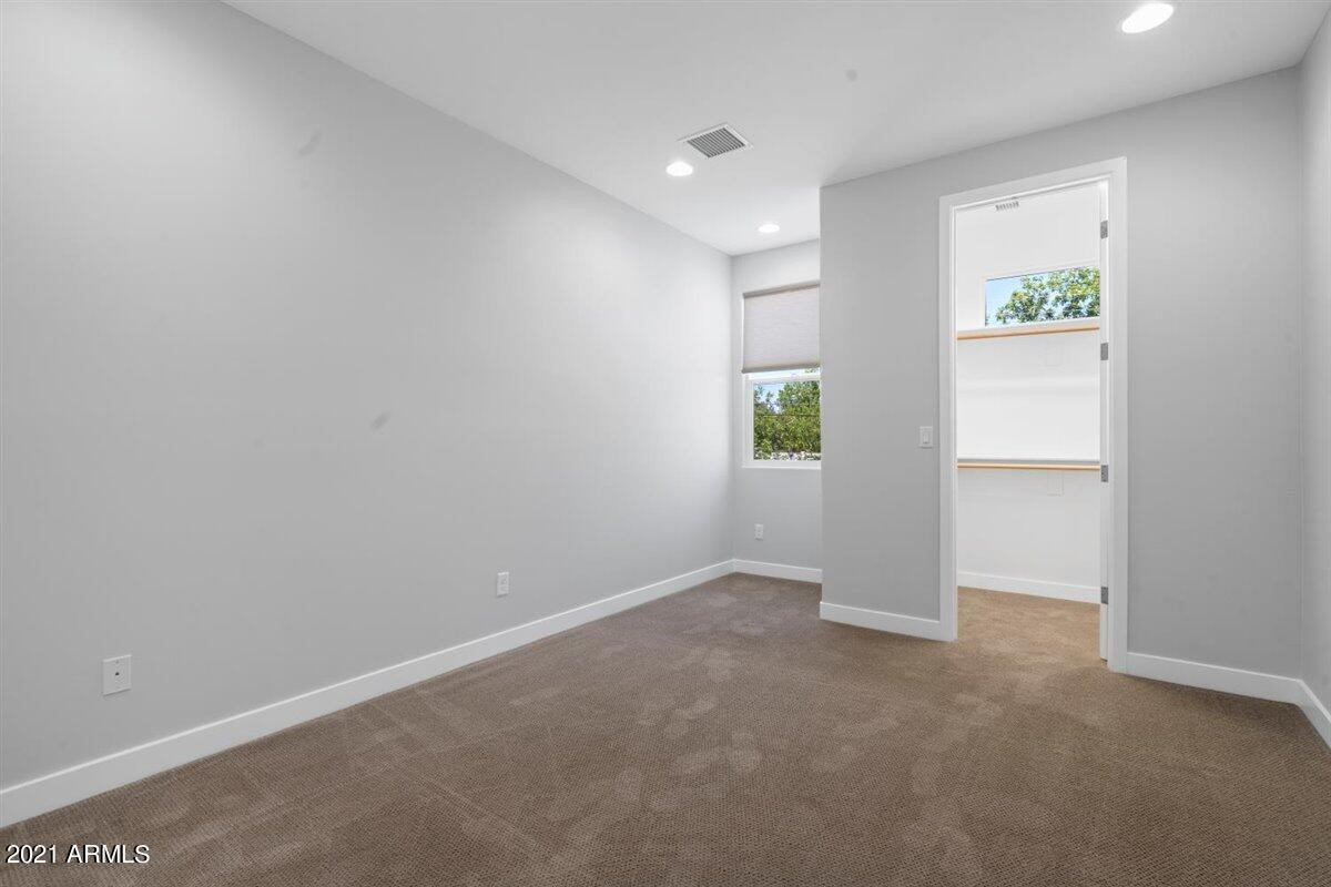 1214 West 5th Street, Unit 2 Tempe, AZ 85281 - Photo 11 of 26 an empty room with windows and closet