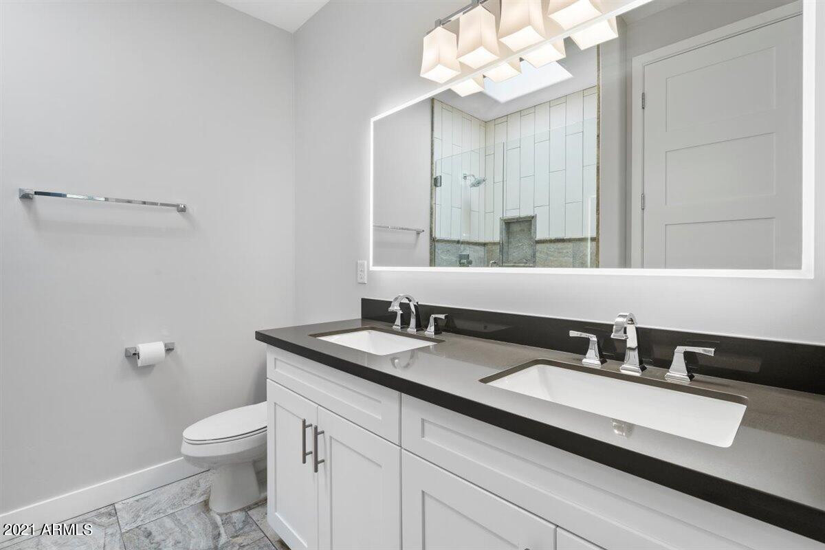 1214 West 5th Street, Unit 2 Tempe, AZ 85281 - Photo 13 of 26 a bathroom with a granite countertop toilet sink and mirror