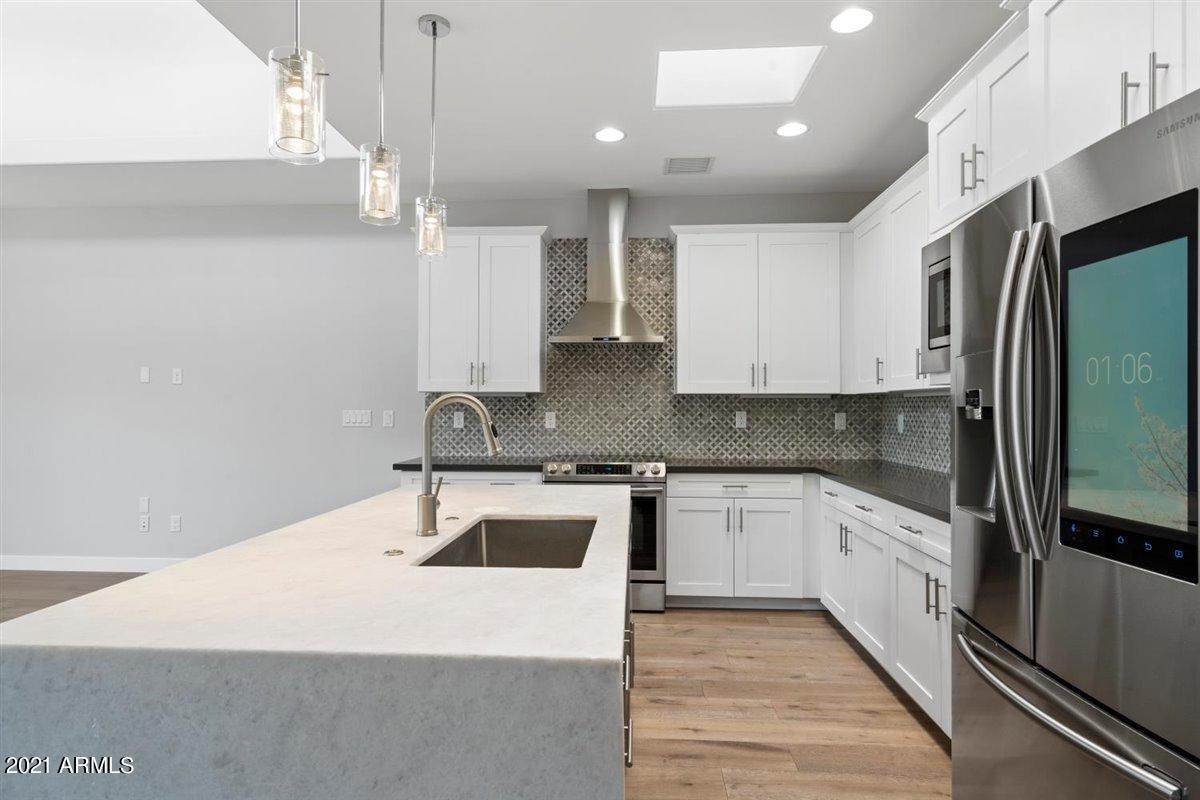 1214 West 5th Street, Unit 2 Tempe, AZ 85281 - Photo 26 of 26 a kitchen with kitchen island a sink stainless steel appliances and cabinets