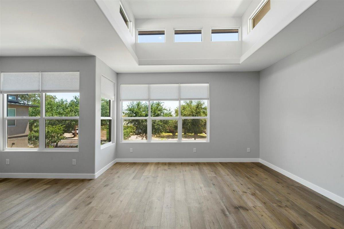 1214 West 5th Street, Unit 2 Tempe, AZ 85281 - Photo 3 of 26 an empty room with wooden floor and windows