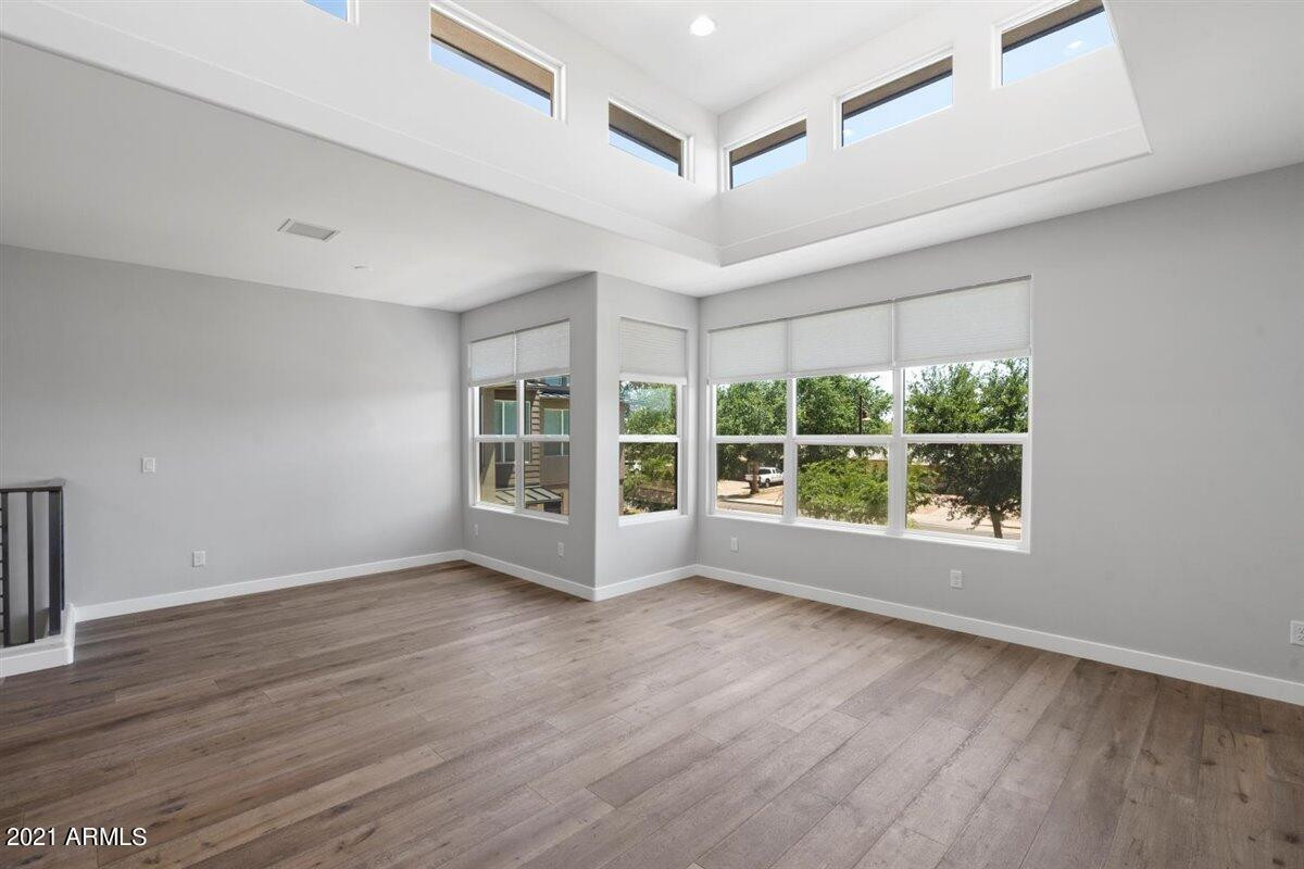 1214 West 5th Street, Unit 2 Tempe, AZ 85281 - Photo 6 of 26 a view of an empty room with wooden floor and a window
