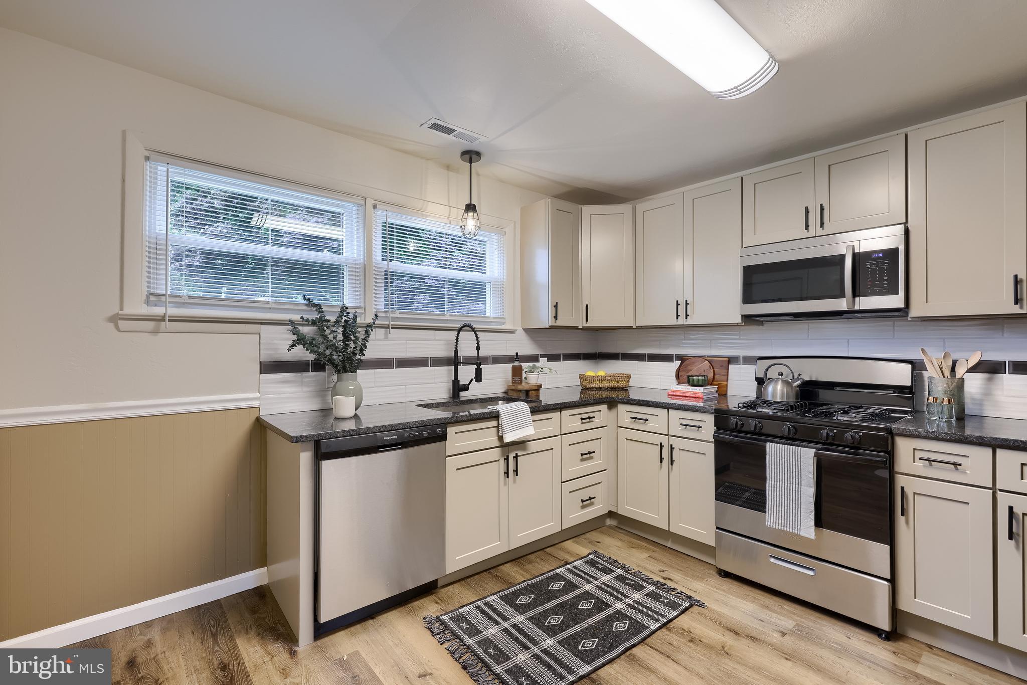 643 Franklin Street Columbia, PA 17512 - Photo 11 of 46 a kitchen with stainless steel appliances granite countertop a sink and cabinets