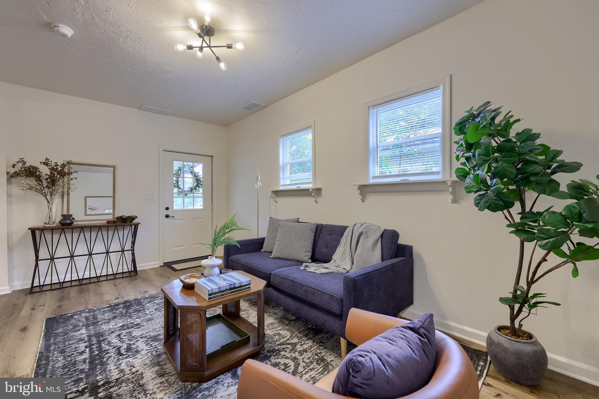 643 Franklin Street Columbia, PA 17512 - Photo 8 of 46 a living room with furniture potted plant and a lamp