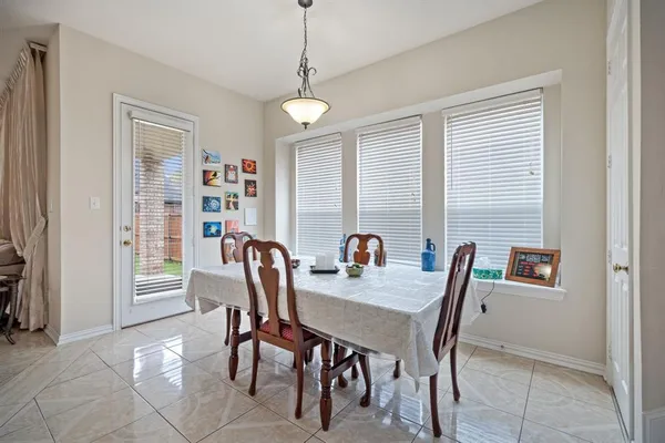 a living room with furniture a fireplace and a large window