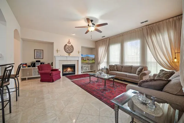 a living room with furniture a table and a large window