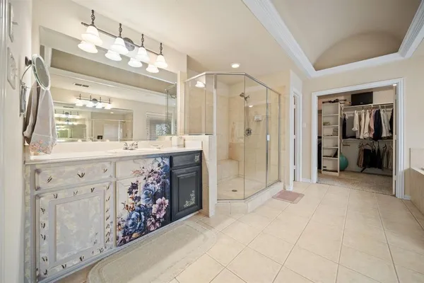 a bathroom with a glass shower door and a sink