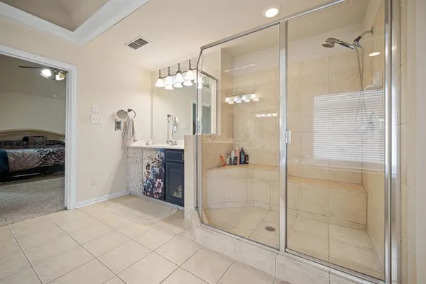 a bathroom with a tub sink and mirror