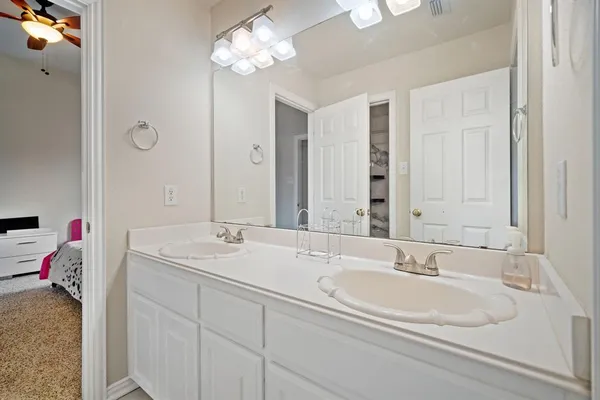 a white toilet sitting next to a bath tub