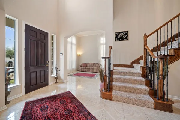 a living room with furniture rug and window