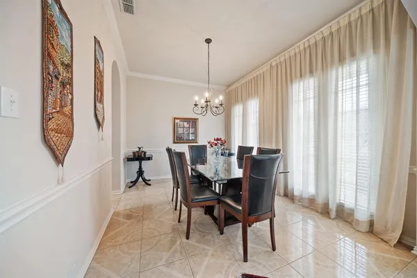 a view of a dining room with furniture and a chandelier
