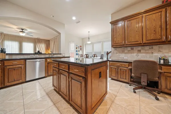 a kitchen with granite countertop cabinets stainless steel appliances and a sink