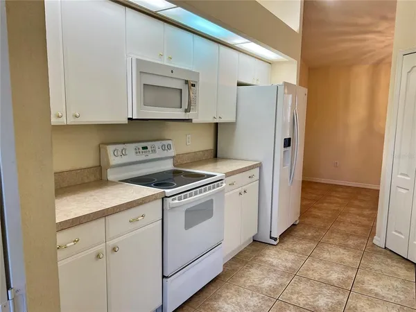 a kitchen with a stove cabinets and a refrigerator