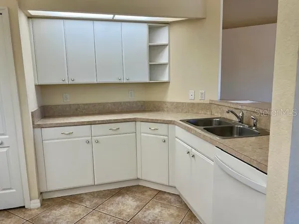 a view of a kitchen with white cabinets