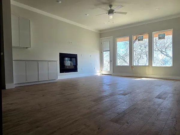 an empty room with windows and closet