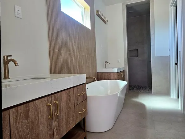 a bathroom with a bathtub and shower