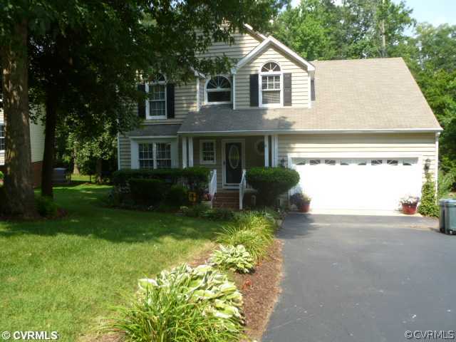 5403 Meadow Chase Road Midlothian, VA 23112 - Photo 1 of 22 a front view of a house with a garden and plants