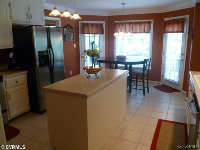5403 Meadow Chase Road Midlothian, VA 23112 - Photo 7 of 22 a kitchen with stainless steel appliances granite countertop sink refrigerator and window