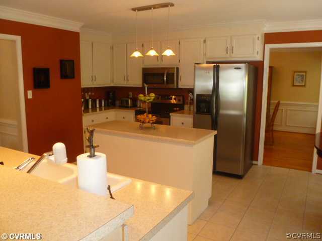 5403 Meadow Chase Road Midlothian, VA 23112 - Photo 8 of 22 a kitchen with stainless steel appliances a refrigerator and a counter top space