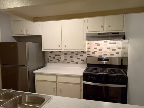 a kitchen with appliances cabinets and a sink
