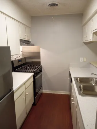 a kitchen with sink a stove and refrigerator