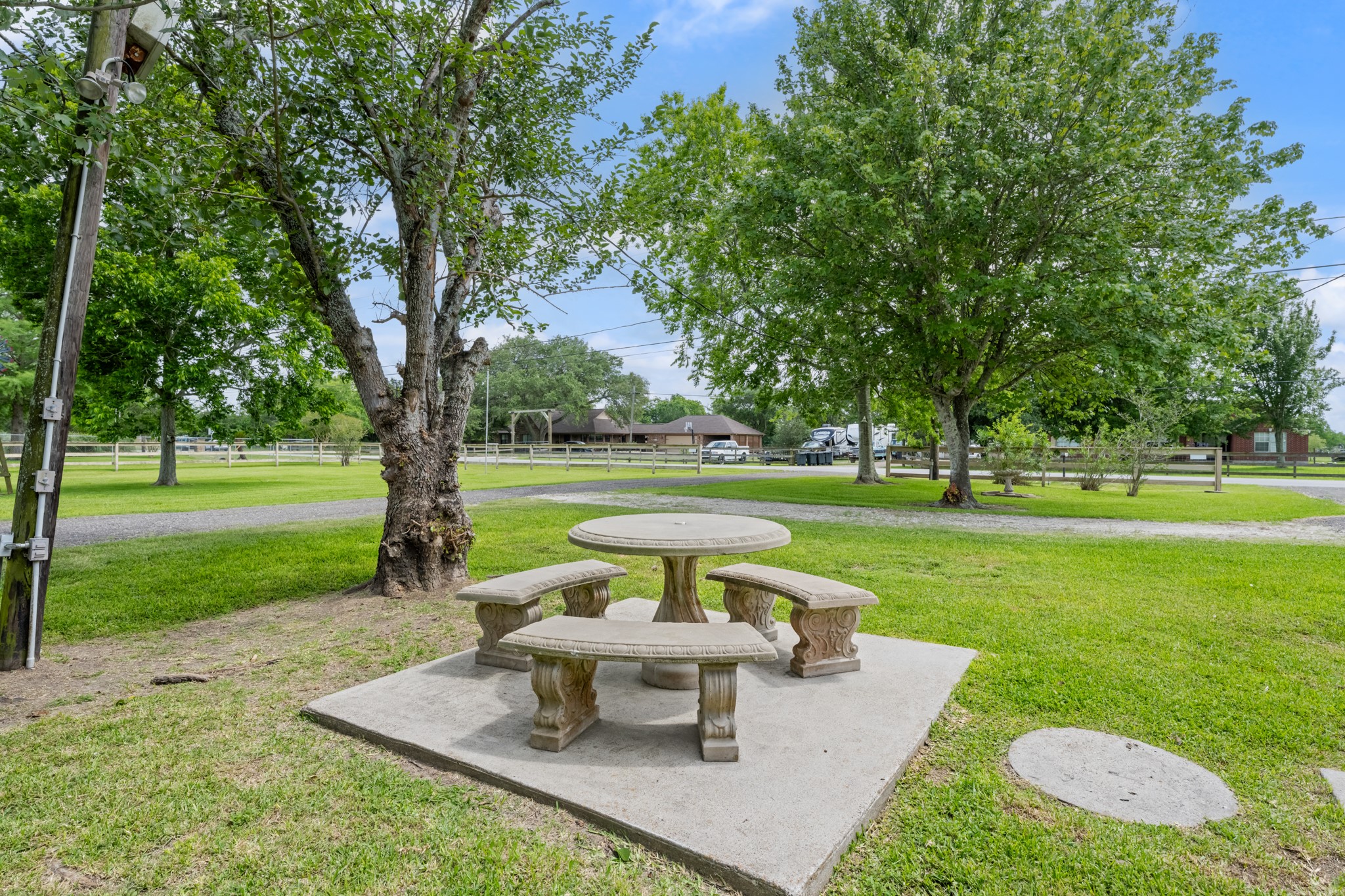 15602 Fir Road Santa Fe, TX 77517 - Photo 27 of 42 Peaceful outdoor seating area surrounded by mature shade trees and expansive green space, offering the perfect setting to relax and enjoy the property’s tranquil surroundings. The spacious yard provides plenty of room for outdoor activities, gardening, or entertaining.