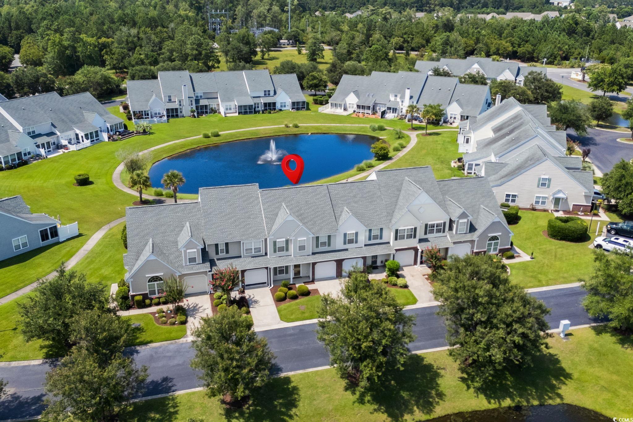 Aerial perspective of suburban area featuring a nearby body of water