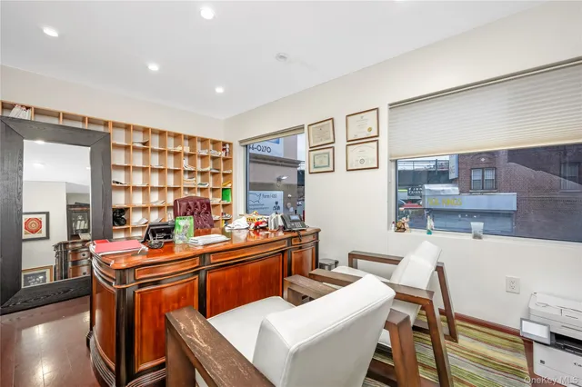 a room with a table chairs and a wooden floor