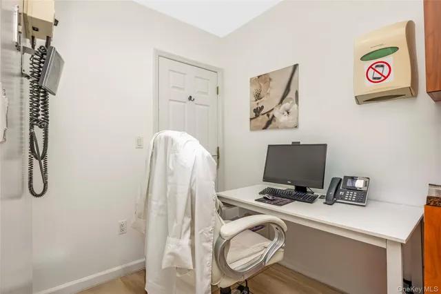 a view of workspace with wooden floor windows