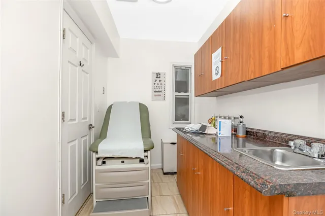 a kitchen with granite countertop a sink stove and cabinets