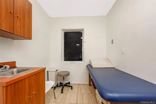a view of a workspace with furniture and wooden floor