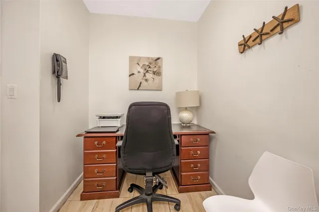 a view of a workspace with furniture and wooden floor