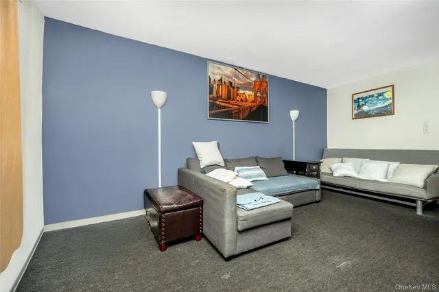 a living room with furniture and a lamp