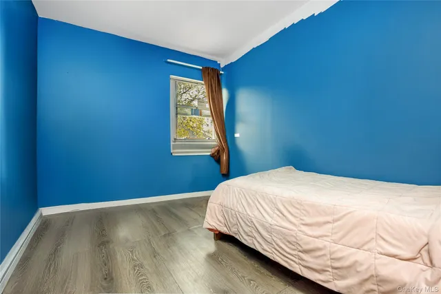 a bed sitting in a bedroom next to a window