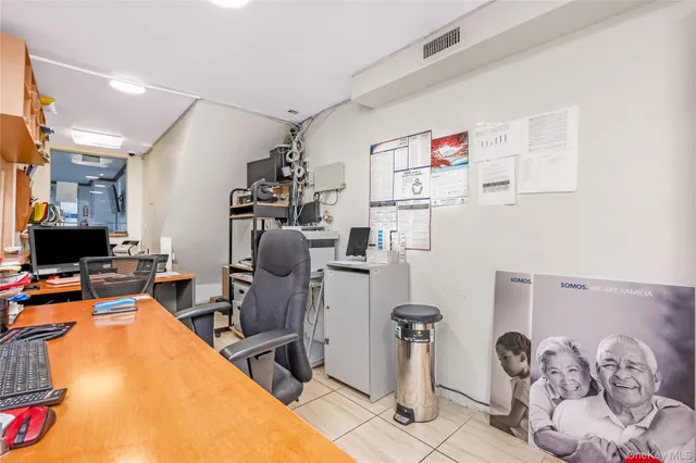 a view of a kitchen with fridge and workspace