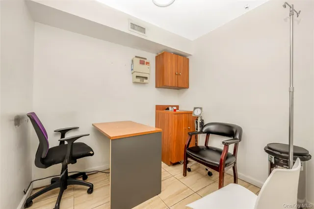a work room with furniture and piano