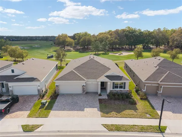 a aerial view of a house with a yard