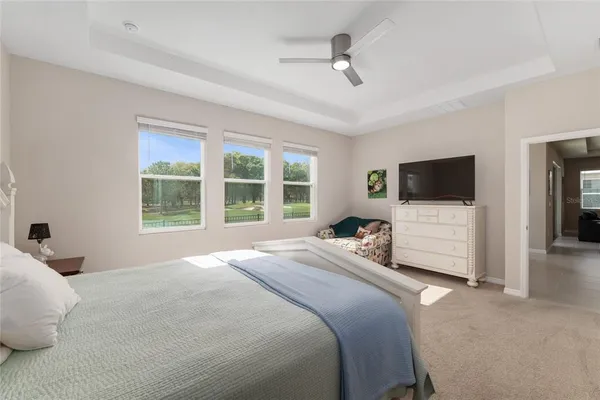 a en suite bathroom with a granite countertop sink and a mirror