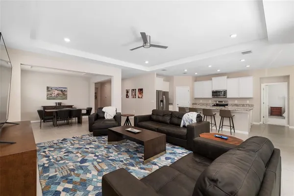 a living room with granite countertop furniture and a flat screen tv
