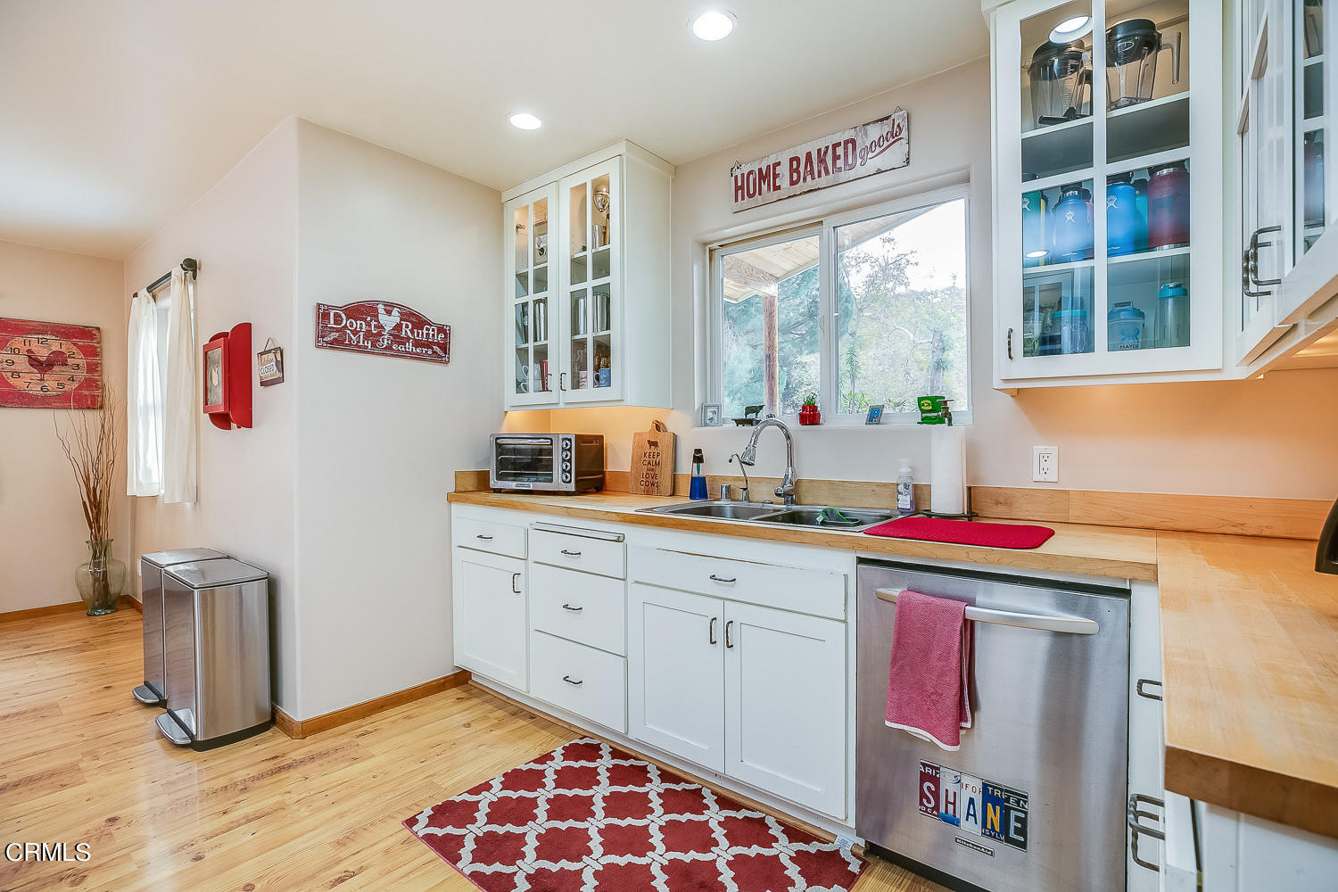 9972 Creek Road Oak View, CA 93022 - Photo 16 of 50 a hall with a stove a sink and a refrigerator