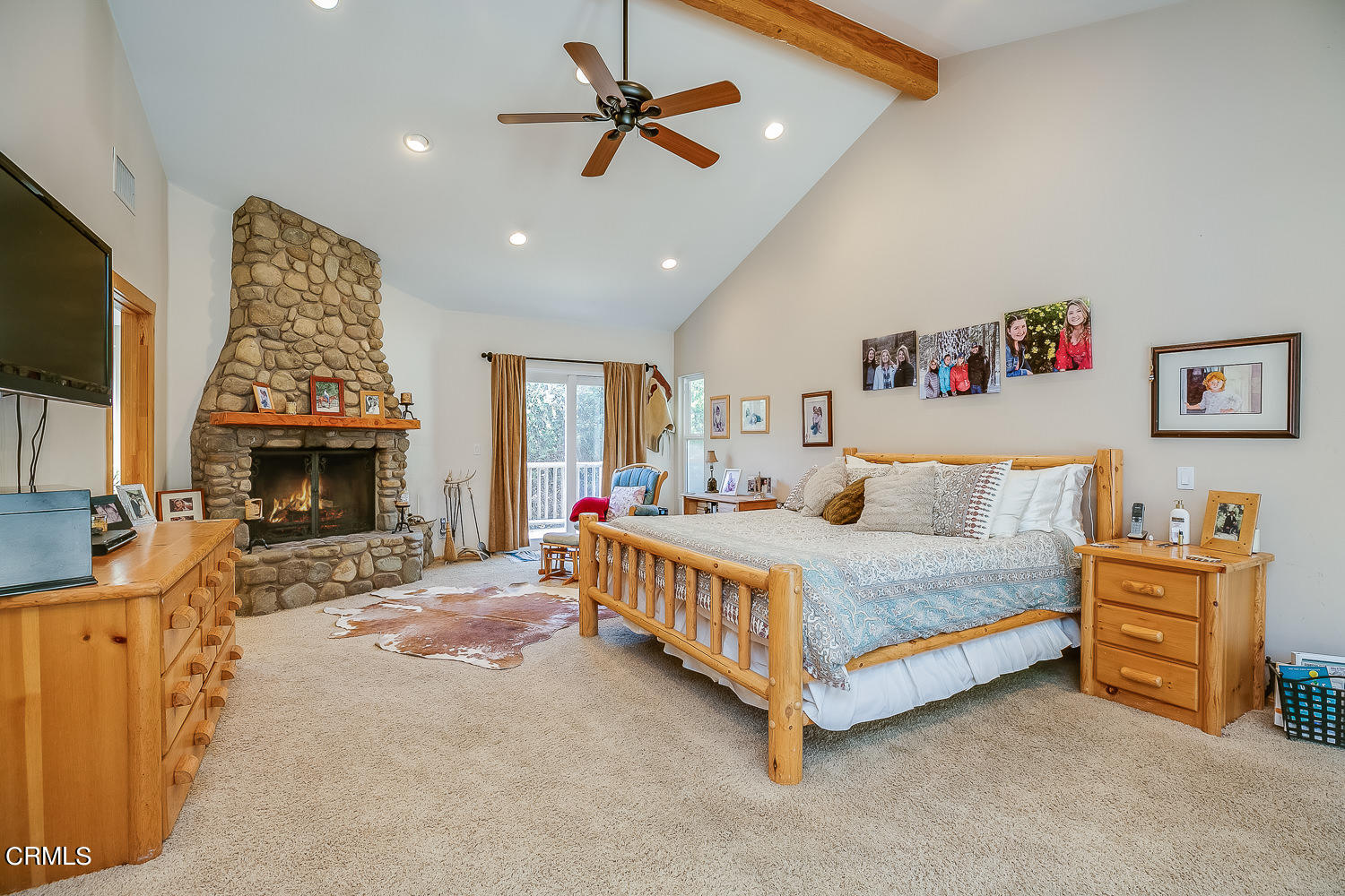 9972 Creek Road Oak View, CA 93022 - Photo 26 of 50 a spacious bedroom with a bed and a fireplace